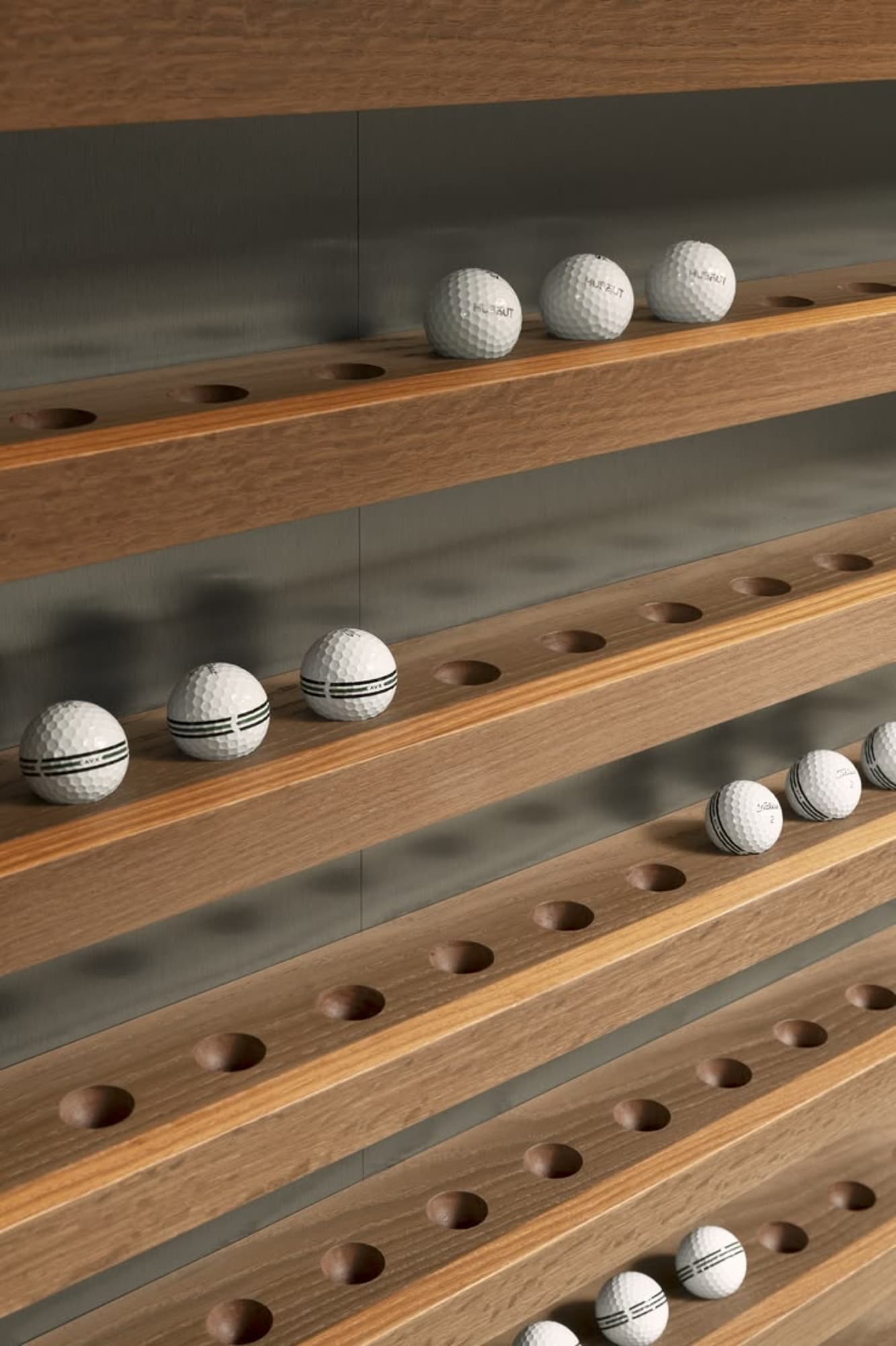 Golf balls displayed on a wooden rack