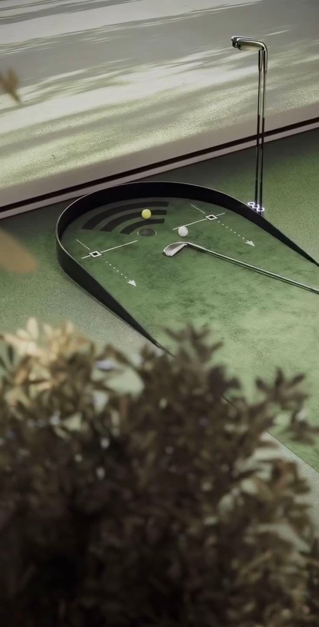 A putting mat set up at home with a putter and two balls